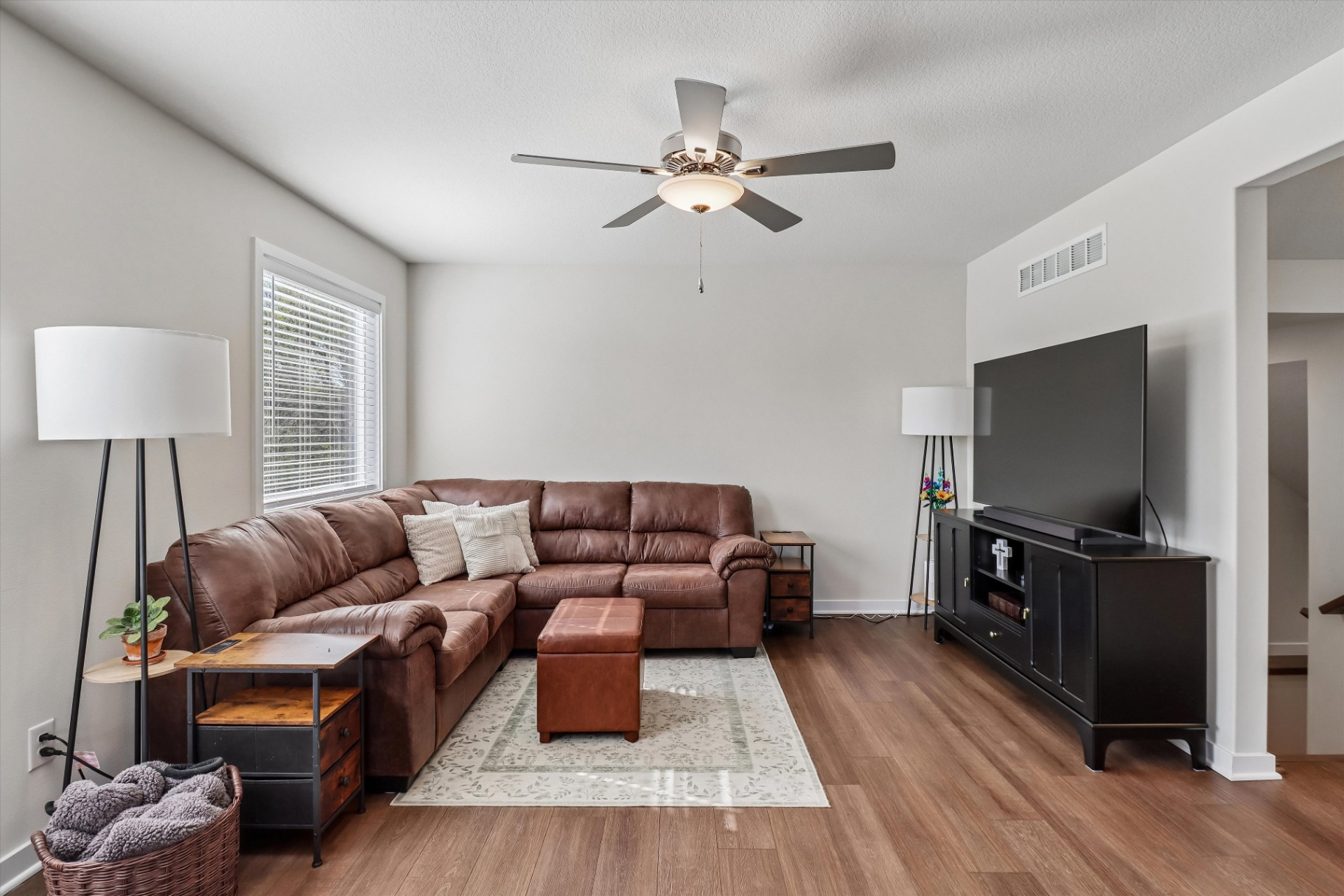 Second living view with entertainment center and natural light