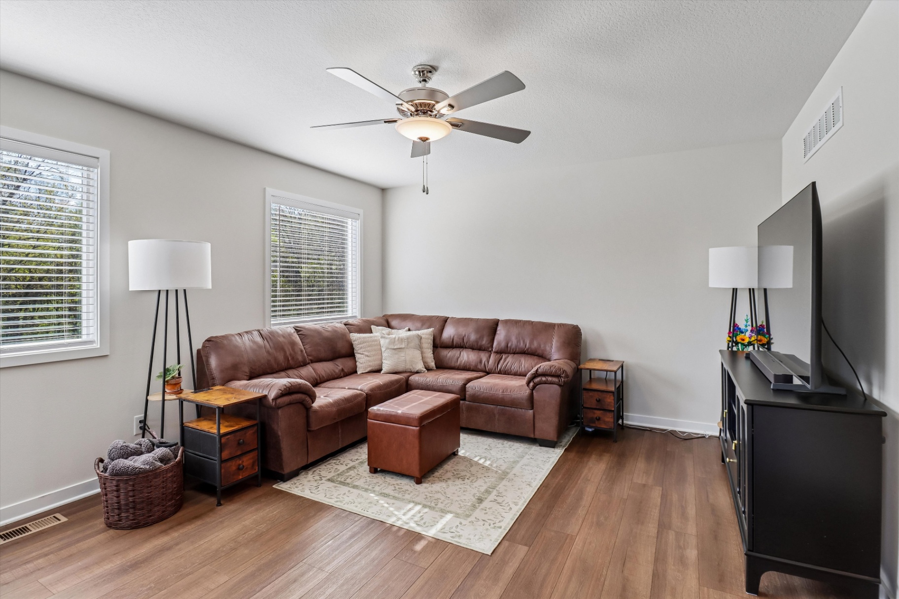 Family room with sectional and big windows to the trees