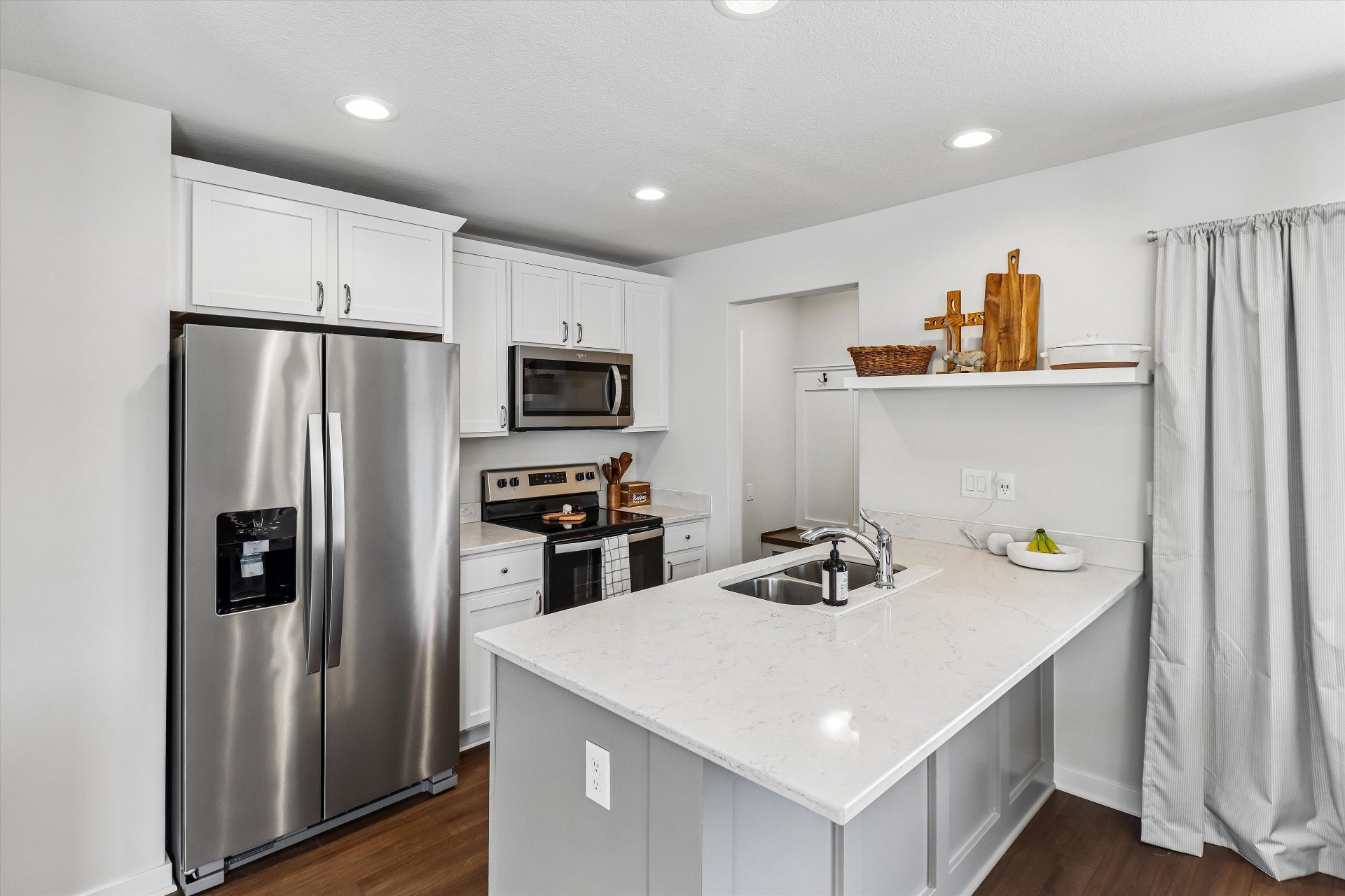Bright white kitchen with oversized quartz island