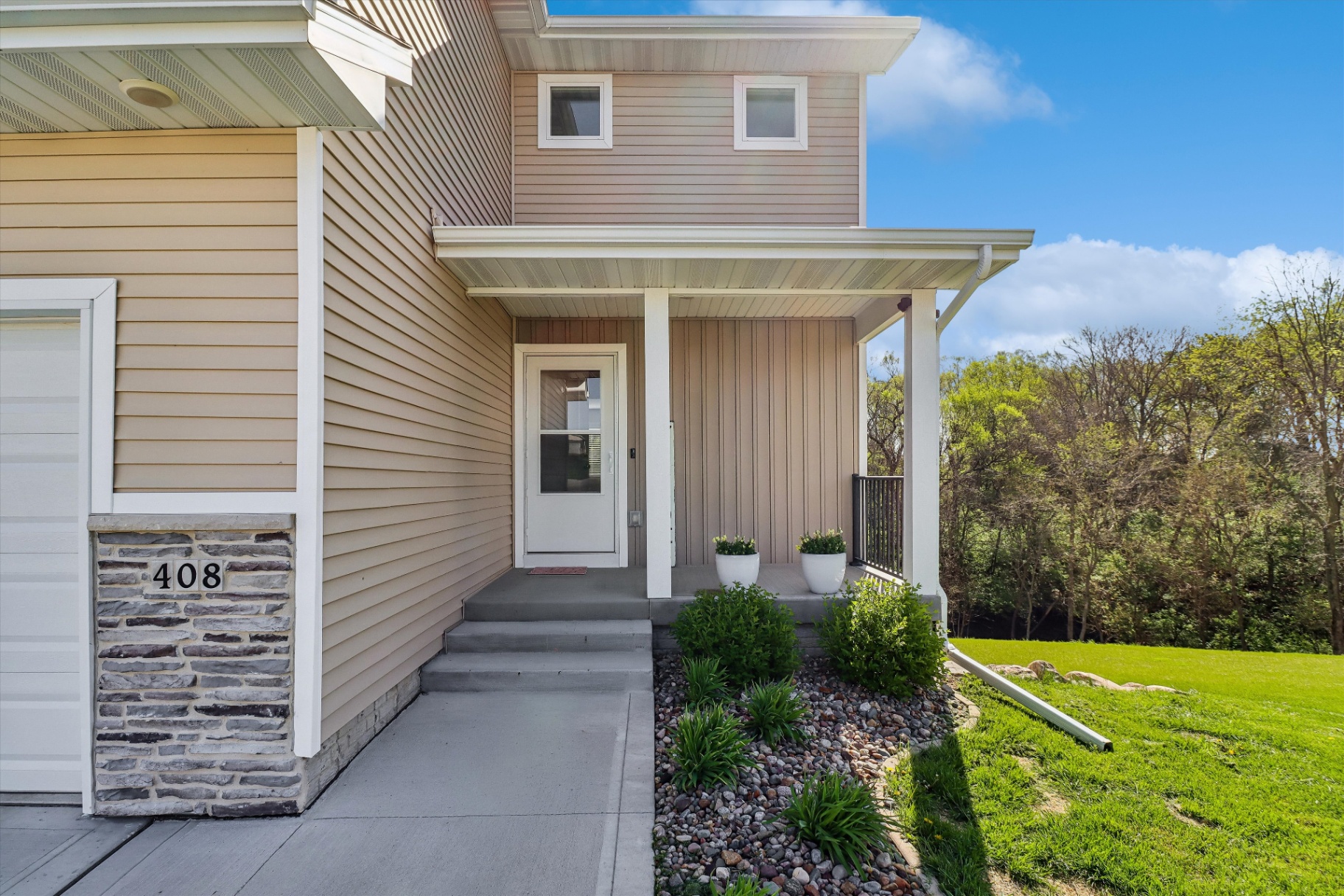 Covered front porch with stone accent and 408 address detail