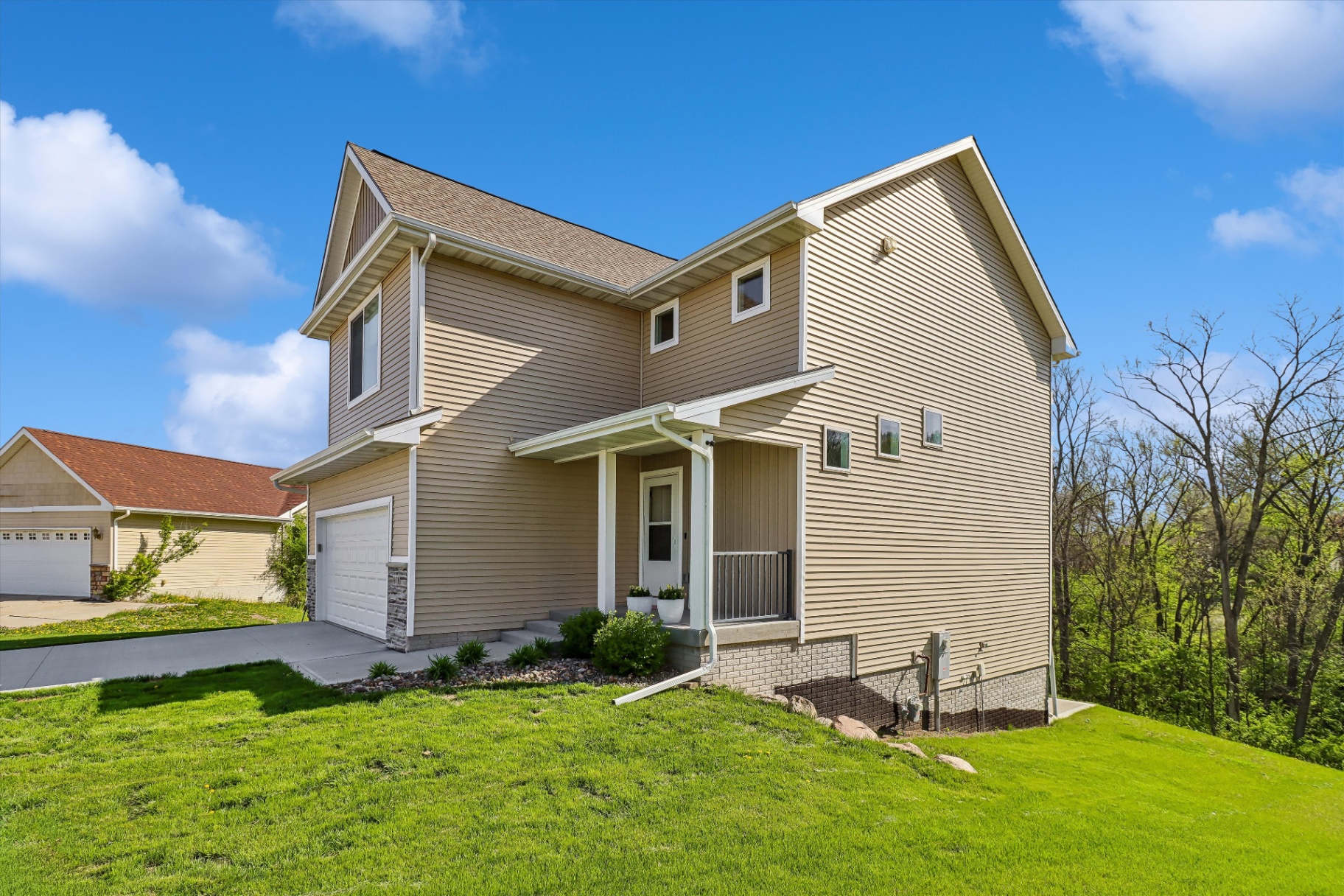 Side elevation backing up to mature trees — no rear neighbors