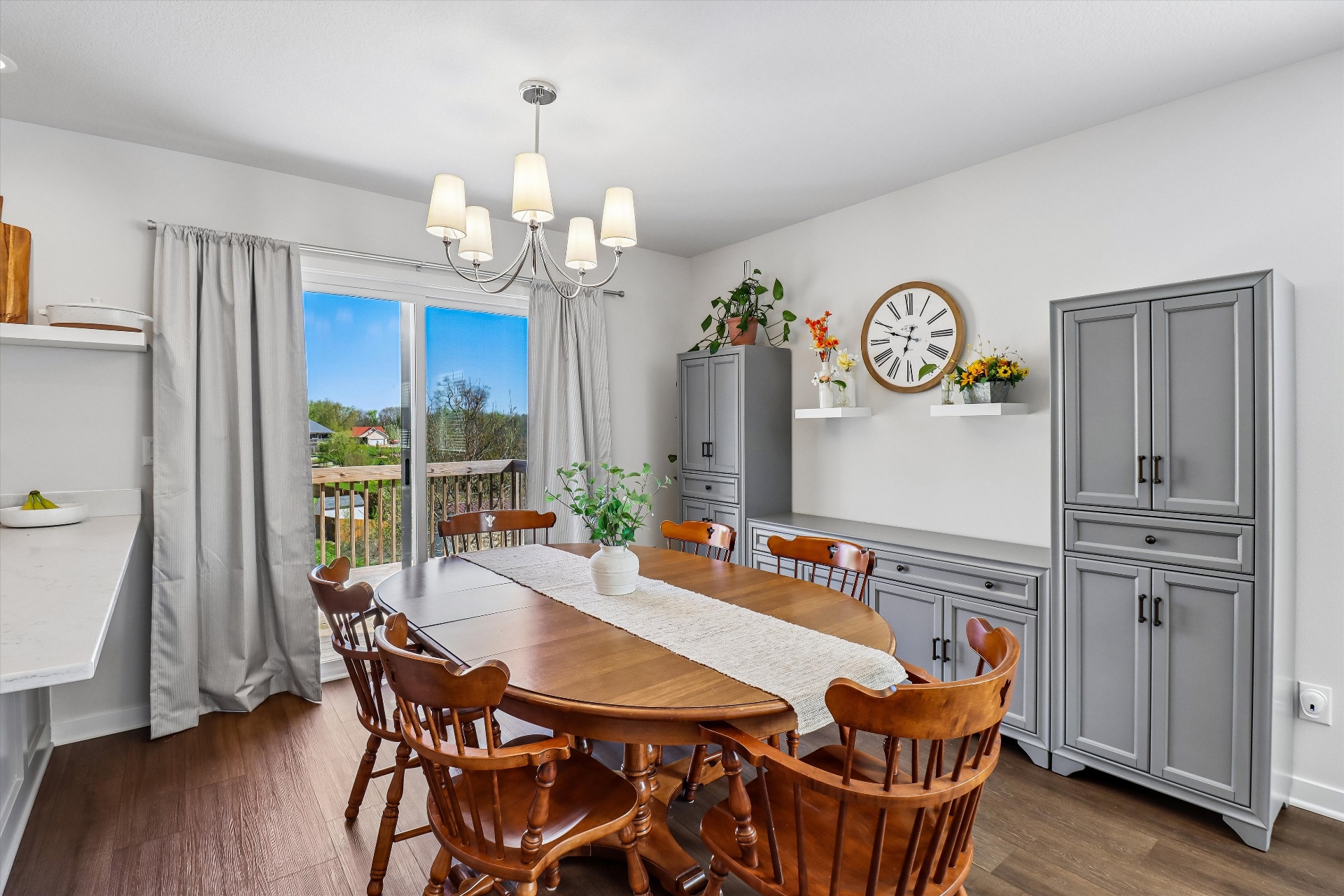 Dining room with chandelier, slider to the deck, and custom built-in hutch