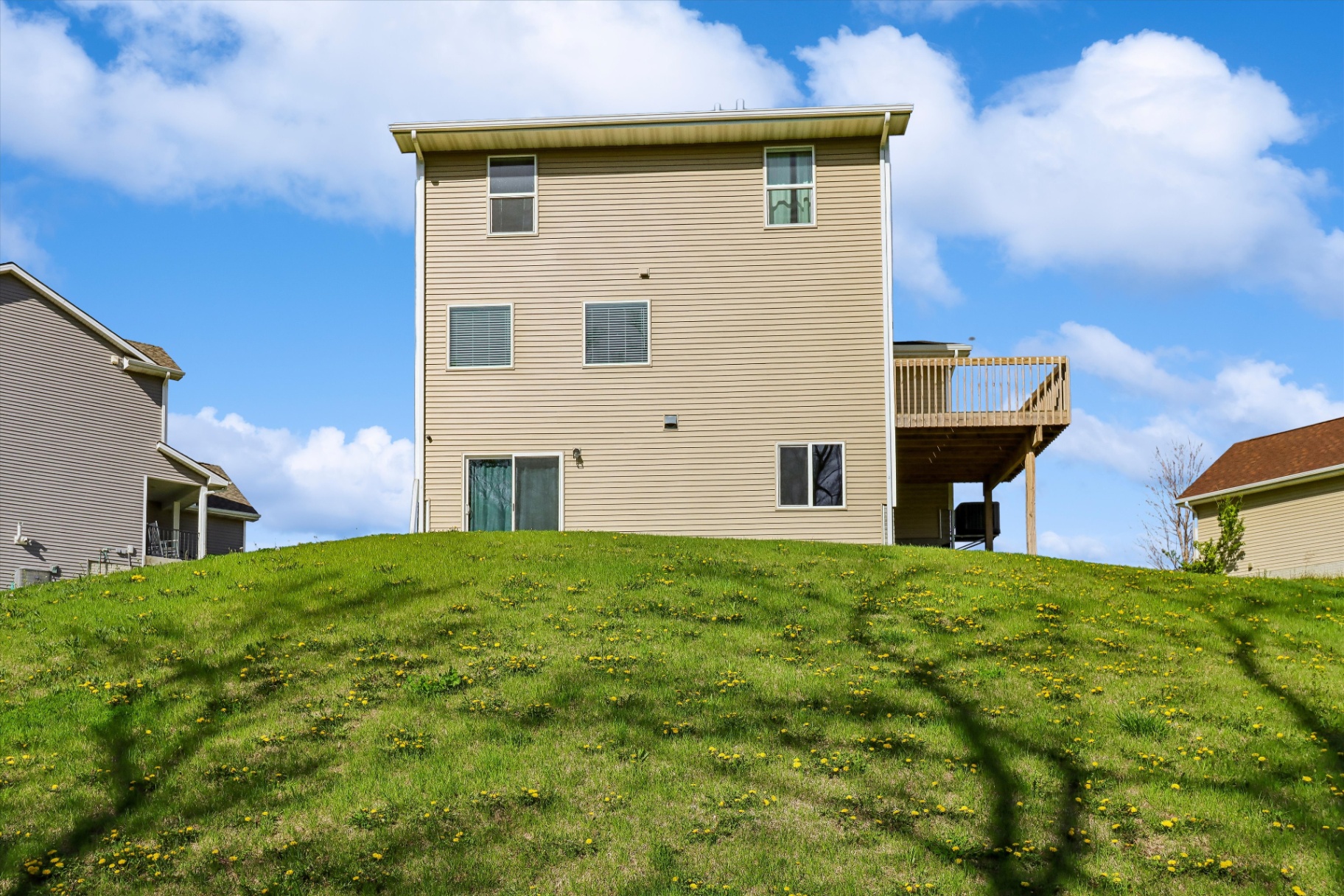 Back of the house showing the full walk-out and deck stack