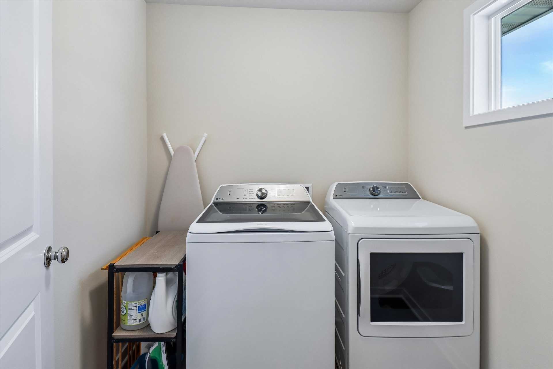 Dedicated upstairs laundry room with side-by-side machines